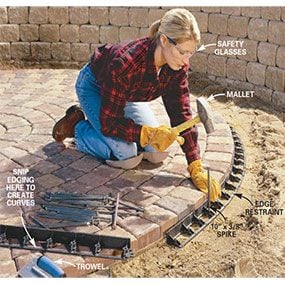 Pull the sand away from the perimeter of the patio