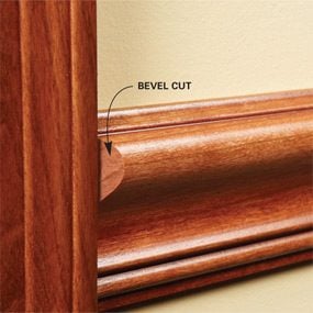 Cut a shallow bevel at the end when you install thick chair rail against thin casing.