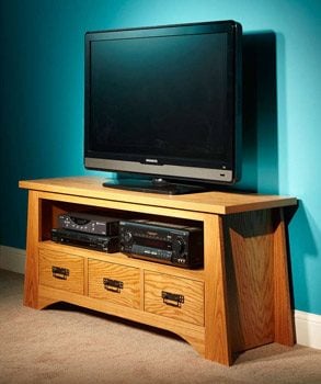 Completed DIY TV stand with a TV, DVD player and other electronics. 