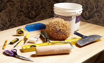 A variety of tools used to hang wallpaper.