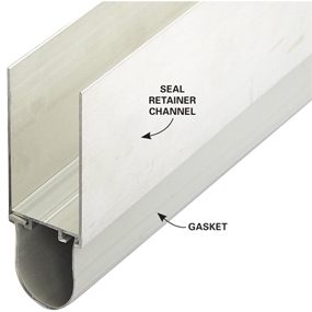 Slide a section of retainer and gasket onto the bottom edge of the garage door. Tilt it until the rubber gasket touches the concrete floor. Then screw the retainer in place.