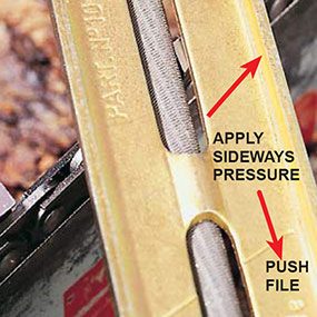 sharpening chainsaw by hand: look through file guide