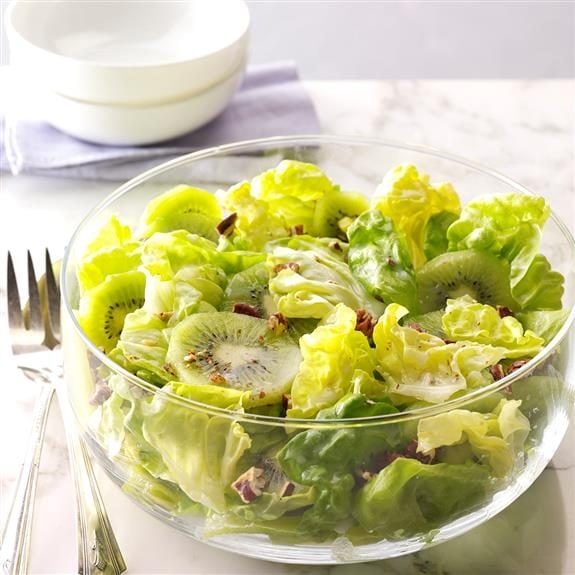 Fresh, green salad topped with kiwi slices