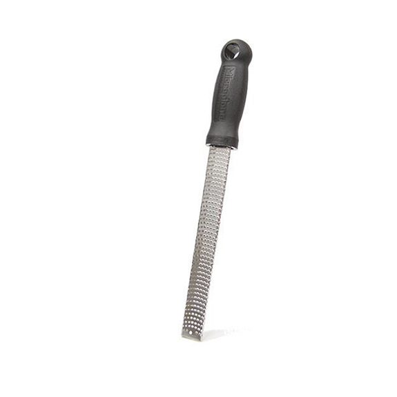 Black-handled, grater angled to have the handle towards the top of the picture on a white background