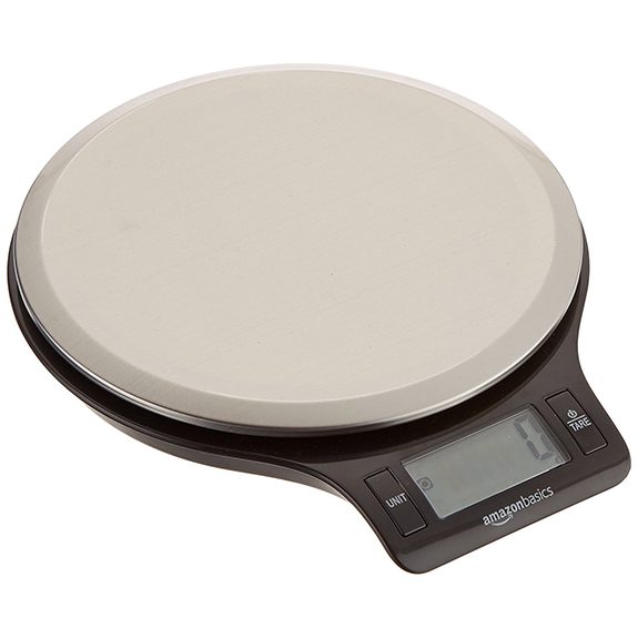 Circular scale with 'Amazonbasics' written above the display screen on the front. The top of the scale is a light gray and the bottom black