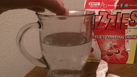 Fizzies tablet being added to a glass of water and fizzing in an endless loop