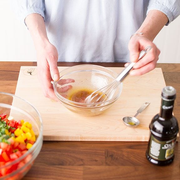 Person whisking ingredients together for a vinaigrette