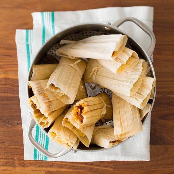 Tamales sitting upright in a stockpot ready to be steamed