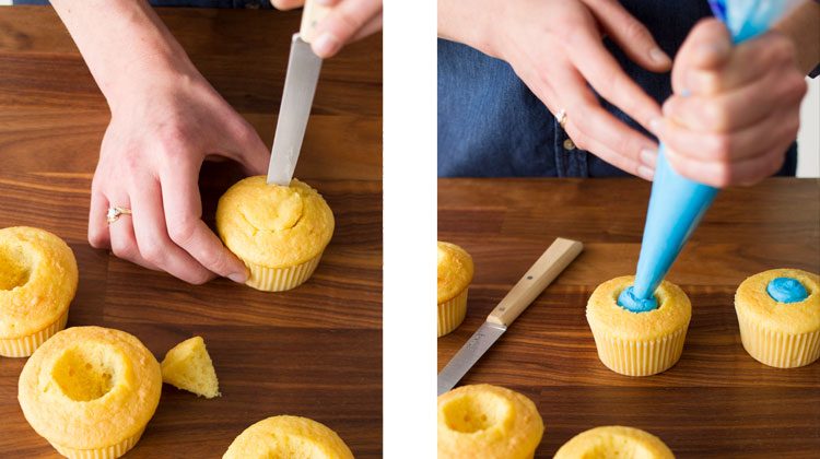 Person cuts a dome shape out of the center of an unfrosted cupcake with a knife. Also, a person piping blue frosting into the middle of the dome cut-out they made before