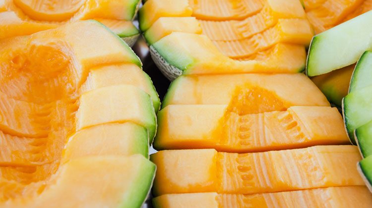 Thick slices of cantaloupe lined up in three rows