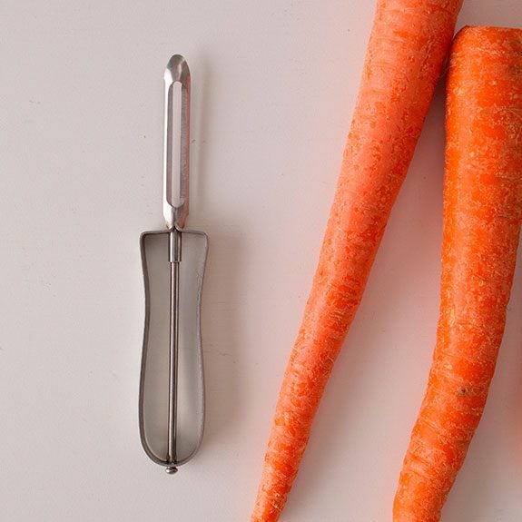 peeler and two un-cut carrots