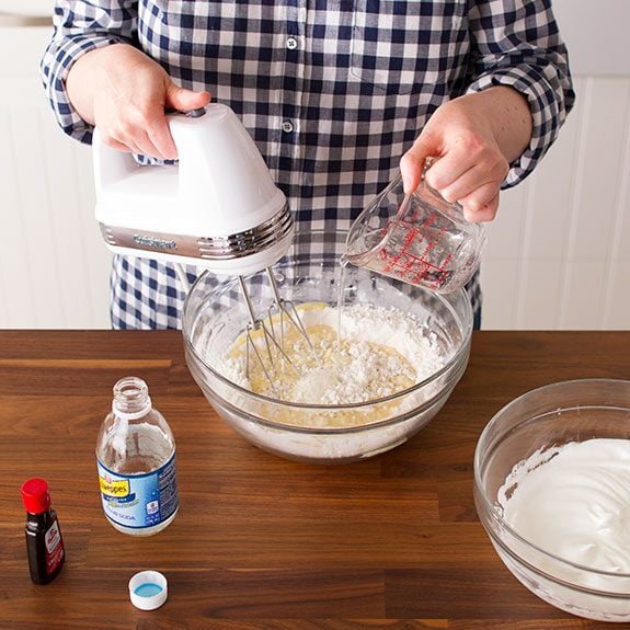 Person using a hand mixer to beat together the dry and wet ingredients